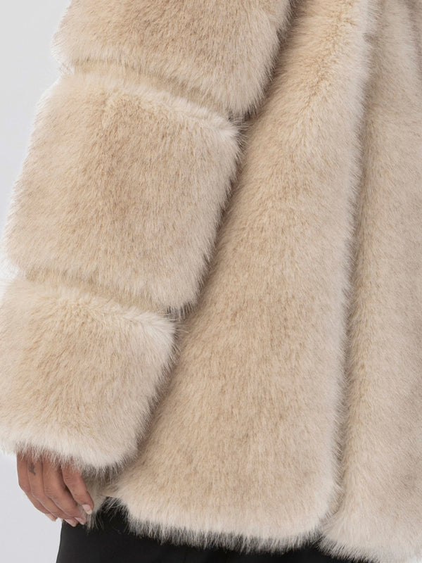 Soft beige faux fur coat with plush, oversized sleeves, perfect for adding warmth and style to any outfit. MEOTINE brand.