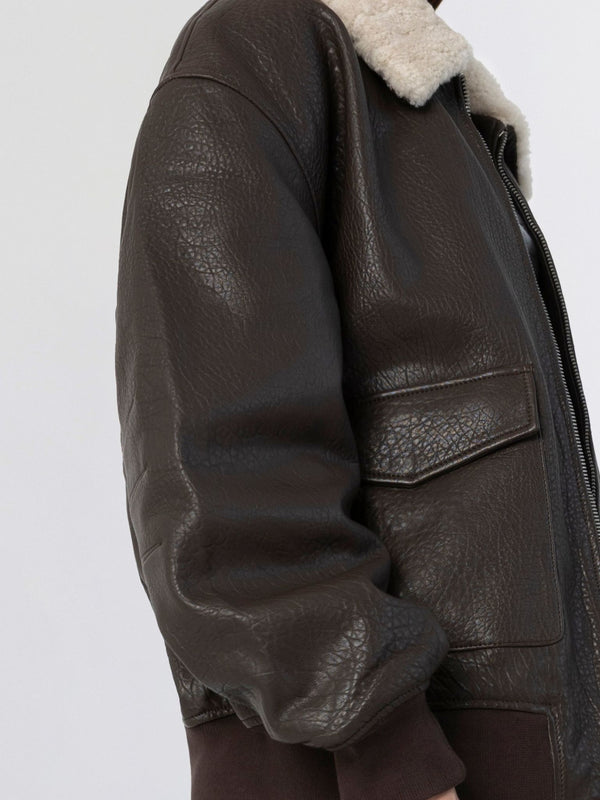 Brown leather jacket with a cozy shearling collar, featuring a zip closure and side pockets, by MEOTINE.