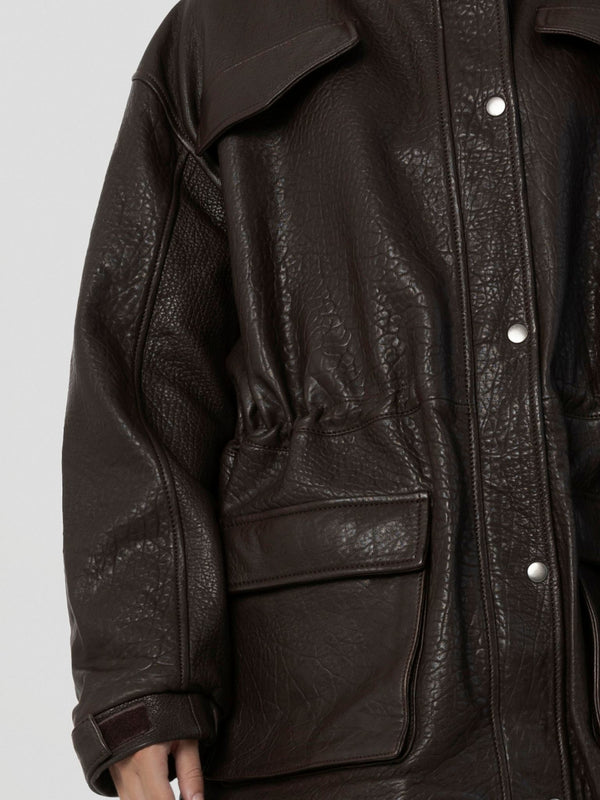 Brown leather jacket with a relaxed fit, featuring a cinched waist and large front pockets, by MEOTINE.