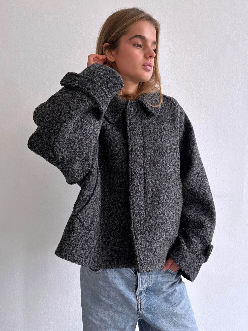 Stylish dark gray cropped jacket with a classic collar and wide sleeves, perfect for a chic, modern look by MEOTINE.
