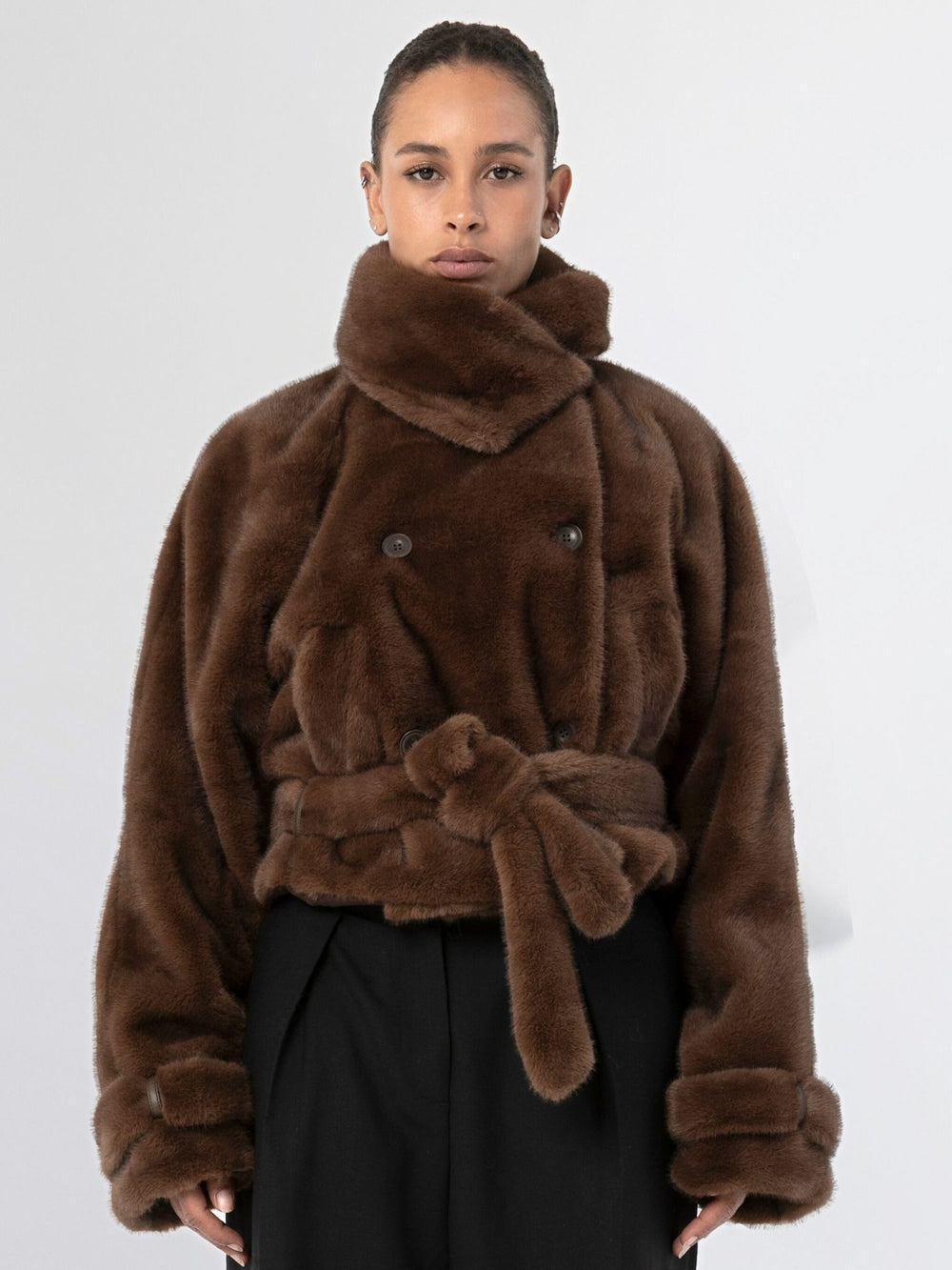 Brown faux fur coat with a belted waist and double-breasted buttons, showcasing a stylish and cozy look by MEOTINE.