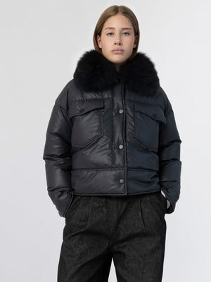 Stylish black puffer jacket with a luxurious fur collar, perfect for winter, by MEOTINE. Model poses confidently.