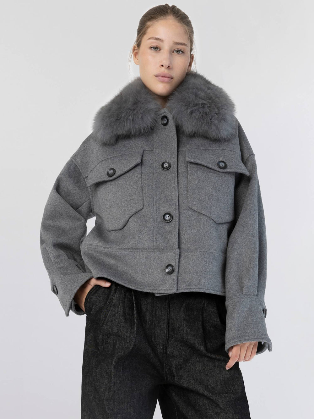 Gray cropped jacket with a fur collar and two front pockets, featuring button closures. Perfect for stylish layering by MEOTINE.
