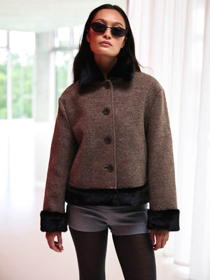 Chic model wearing a brown wool jacket with faux fur trim and sunglasses, showcasing MEOTINE's stylish winter collection.