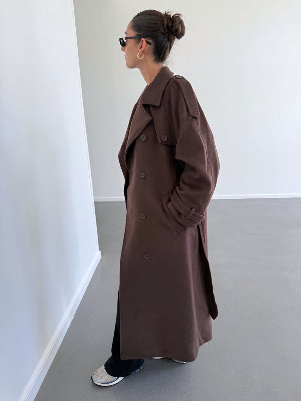 A model showcases a stylish brown trench coat from MEOTINE, featuring a relaxed fit and classic double-breasted design.