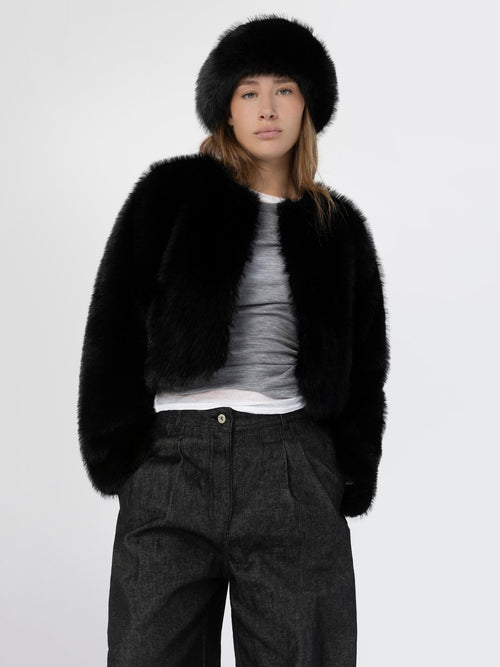 A model showcases a stylish black faux fur jacket paired with a matching hat, exuding elegance and warmth by MEOTINE.