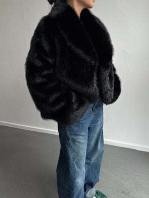 Stylish black faux fur jacket with a wide collar, paired with loose denim jeans, showcasing a chic winter look by MEOTINE.