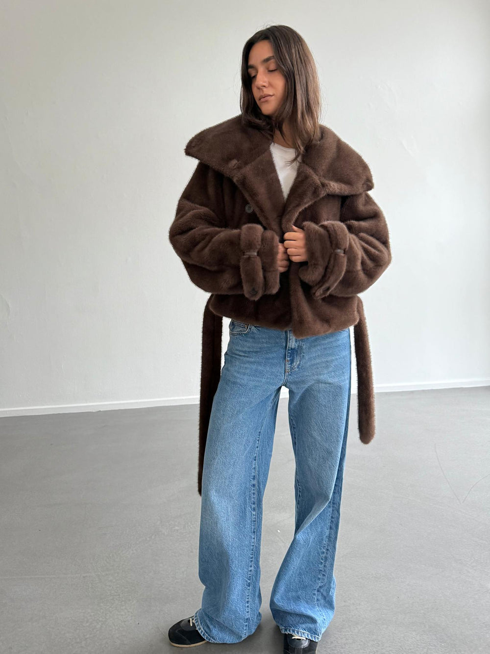 Brown faux fur coat with a belted waist and double-breasted buttons, showcasing a stylish and cozy look by MEOTINE.