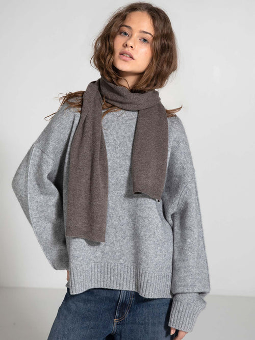 Cozy gray oversized sweater paired with a stylish brown scarf, showcasing MEOTINE's chic and comfortable fashion aesthetic.