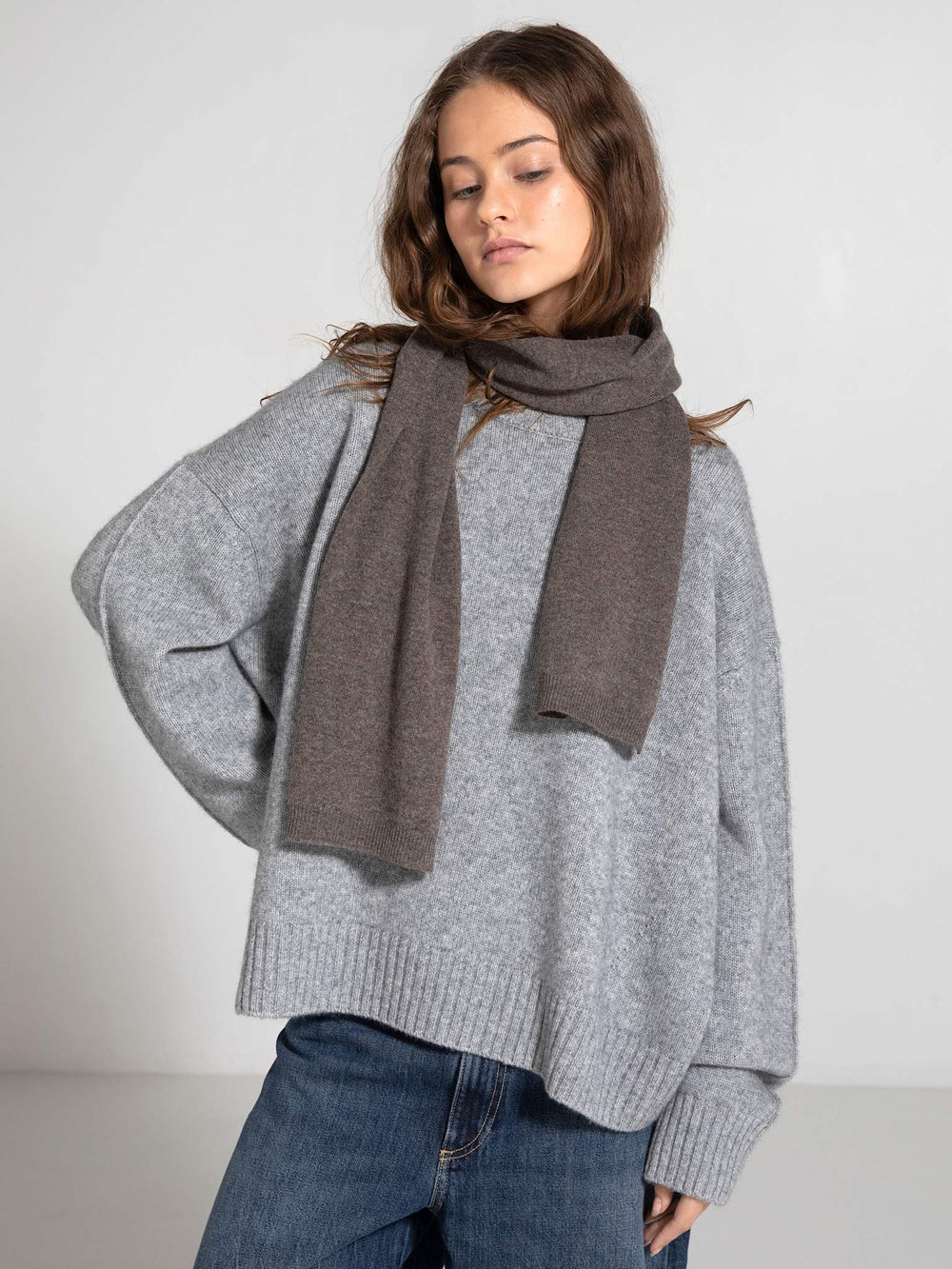 Cozy gray oversized sweater paired with a stylish brown scarf, showcasing MEOTINE's chic and comfortable fashion aesthetic.
