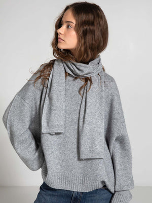 Cozy gray sweater with a matching scarf, styled effortlessly, showcasing MEOTINE's chic and comfortable fashion aesthetic.