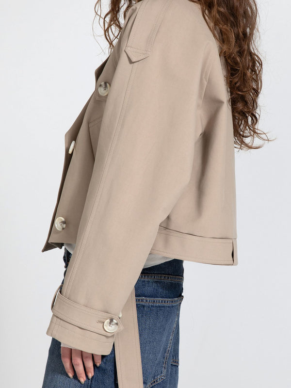 Stylish beige cropped jacket with large buttons, featuring a relaxed fit and side tie detail, perfect for a trendy look by MEOTINE.
