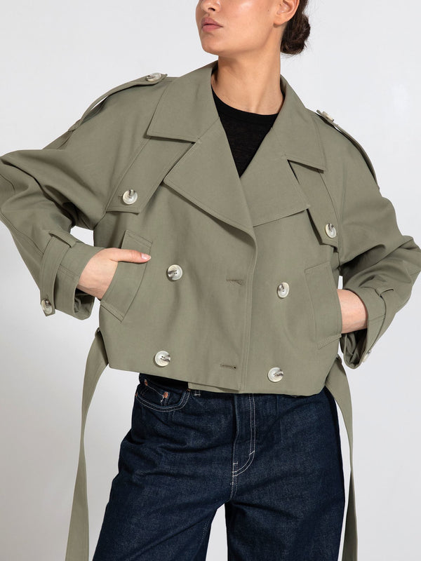 Stylish cropped trench coat in olive green with double-breasted buttons and side ties, perfect for a chic look by MEOTINE.