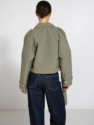 Stylish cropped jacket in olive green with unique shoulder details, paired with high-waisted denim, showcasing MEOTINE's modern design.