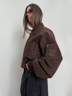 Stylish brown cropped jacket with oversized sleeves, paired with sleek black pants and sunglasses, showcasing MEOTINE's modern design.