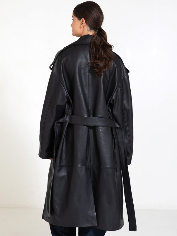 A model showcases a stylish black leather trench coat with a belted waist, exuding elegance and sophistication by MEOTINE.