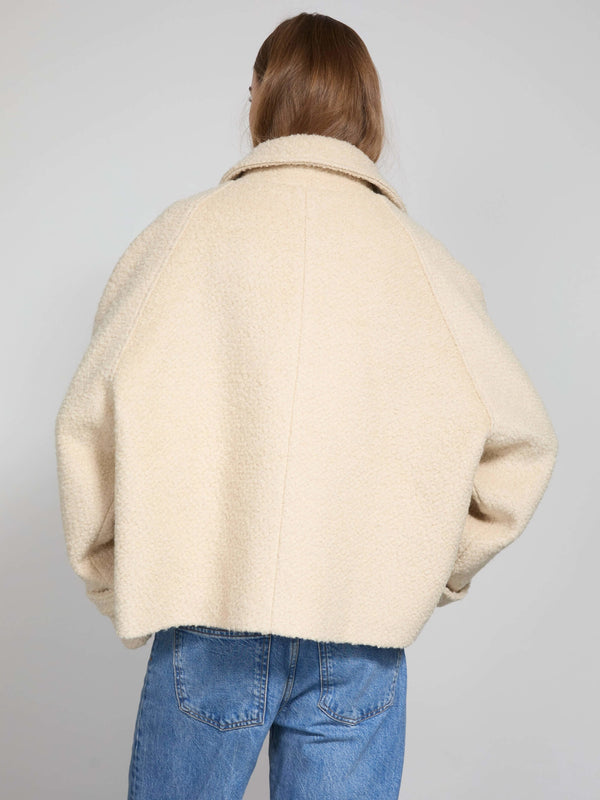 Cozy cream-colored oversized jacket with a soft texture, perfect for layering, designed by MEOTINE.