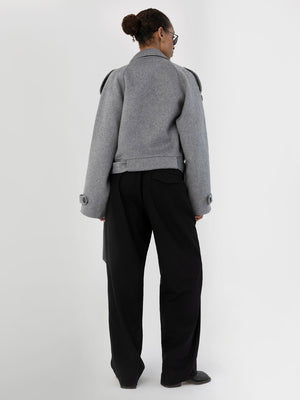 Stylish gray cropped jacket with oversized sleeves, paired with black wide-leg trousers, showcasing a modern look by MEOTINE.