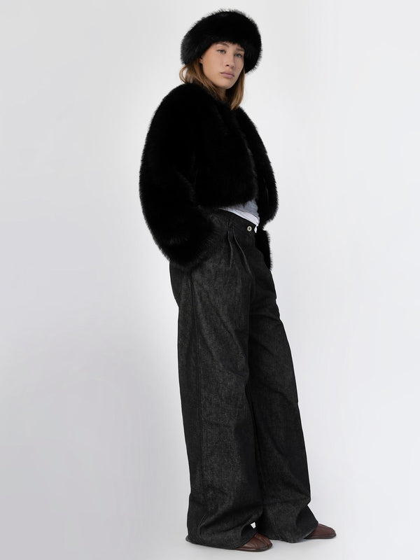 A model showcases a stylish black fur coat and matching hat, paired with wide-leg dark trousers, embodying MEOTINE's chic aesthetic.