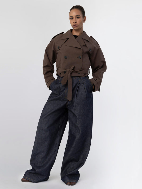 A model showcases a stylish brown double-breasted jacket paired with wide-leg denim pants, embodying MEOTINE's modern aesthetic.