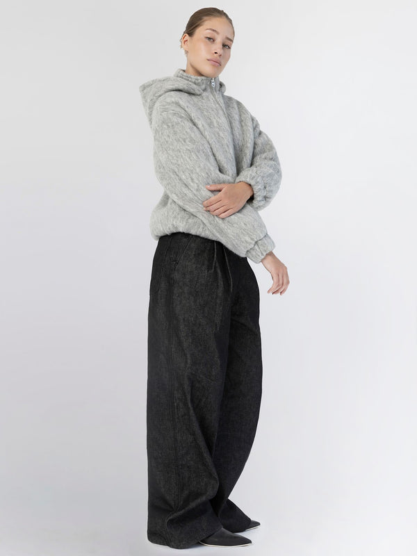A model showcases a cozy gray hoodie paired with loose black pants, embodying a relaxed style by MEOTINE.