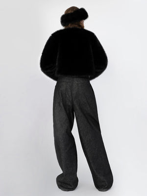 A model wearing a black faux fur jacket and wide-leg black pants, showcasing a chic and cozy look by MEOTINE.