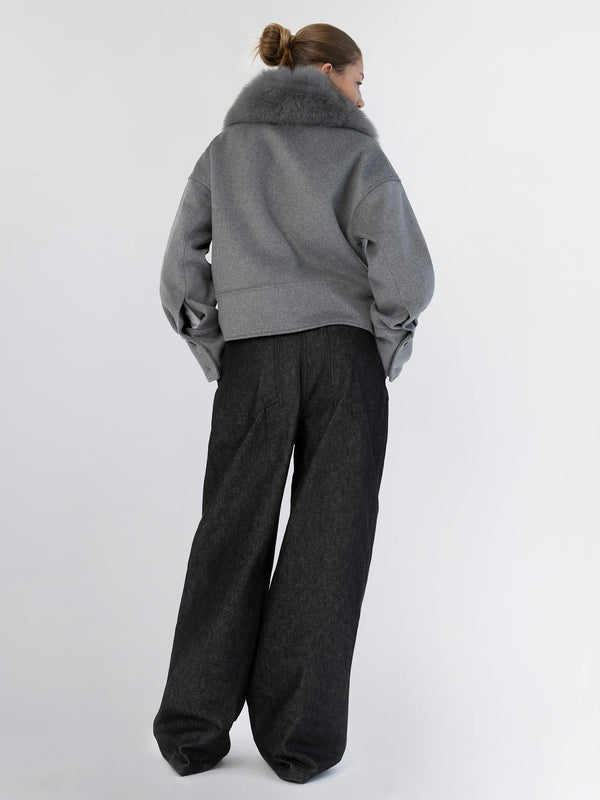 A model showcases a stylish gray cropped jacket with a fur collar, paired with wide-leg black trousers, embodying MEOTINE's chic aesthetic.