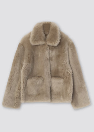 Luxurious beige faux fur jacket with a classic collar and two front pockets, perfect for stylish warmth by MEOTINE.
