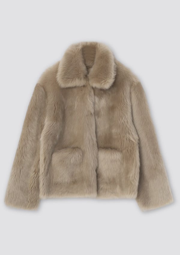 Luxurious beige faux fur jacket with a classic collar and two front pockets, perfect for stylish warmth by MEOTINE.