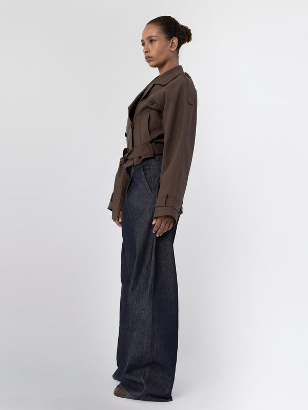 A model showcases a stylish brown jacket paired with wide-leg denim jeans, embodying MEOTINE's modern aesthetic.