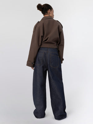 A model showcases a stylish brown cropped jacket paired with high-waisted, wide-leg denim jeans from MEOTINE.