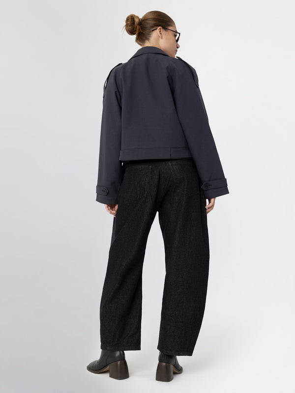 Stylish navy cropped jacket paired with wide-leg black trousers, showcasing a modern look by MEOTINE.