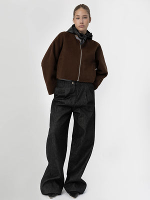 A model showcases a stylish brown cropped jacket paired with wide-leg black jeans, embodying modern fashion by MEOTINE.