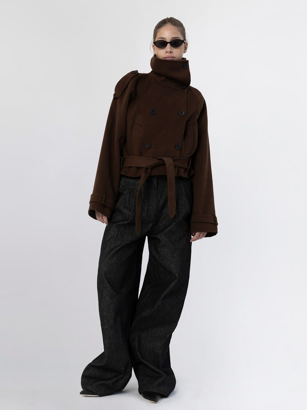 A model showcases a stylish brown oversized coat with a belt and high collar, paired with wide-leg black pants, embodying MEOTINE's chic aesthetic.