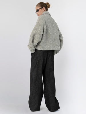 A model showcases a stylish gray oversized jacket paired with wide-leg black trousers, embodying MEOTINE's modern aesthetic.