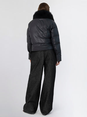 Stylish black puffer jacket with a fur collar, paired with wide-leg dark trousers, showcasing a modern winter look by MEOTINE.