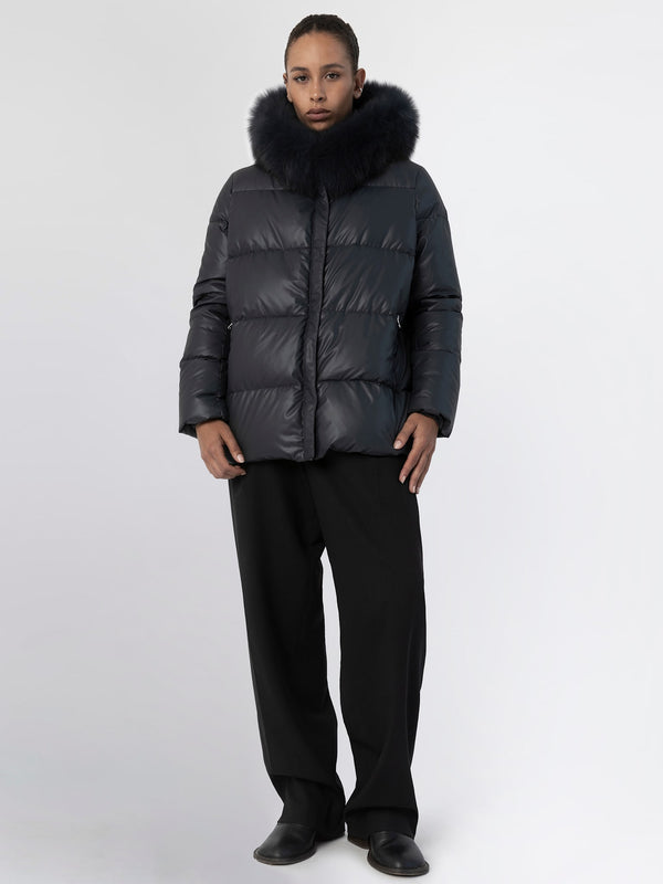 A model wears a stylish black puffer jacket with a luxurious fur collar, showcasing MEOTINE's modern winter fashion.