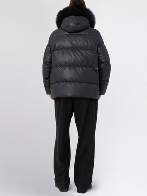 Stylish black puffer jacket with a fur-trimmed hood, perfect for winter, featuring a relaxed fit and cozy design by MEOTINE.