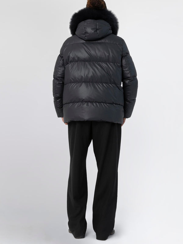 Stylish black puffer jacket with a fur-trimmed hood, perfect for winter, featuring a relaxed fit and cozy design by MEOTINE.