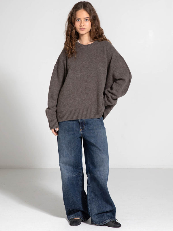 Cozy brown oversized sweater paired with wide-leg jeans, showcasing a relaxed style perfect for casual outings. MEOTINE.