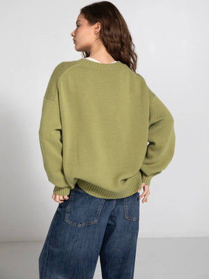 Cozy oversized green sweater with a relaxed fit, paired with loose denim jeans, showcasing a casual, stylish look by MEOTINE.