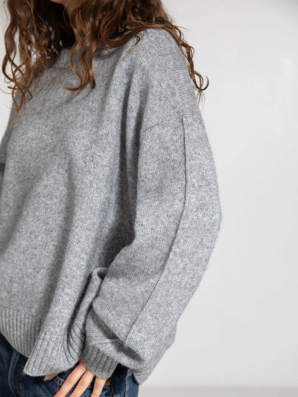 Cozy gray sweater with a relaxed fit and ribbed hem, perfect for layering. A stylish choice from MEOTINE.