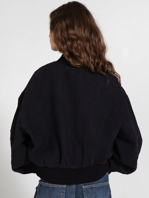 Stylish black oversized jacket with a ribbed hem, featuring a relaxed fit and soft fabric, perfect for casual wear. MEOTINE.