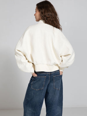 Cozy cream oversized jacket with a textured finish, featuring a relaxed fit and ribbed hem, perfect for casual wear. MEOTINE.