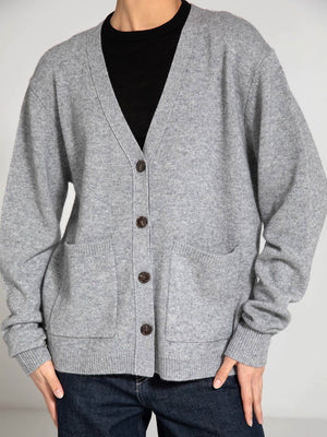Cozy gray cardigan with a V-neck, button closure, and front pockets, perfect for layering. By MEOTINE.
