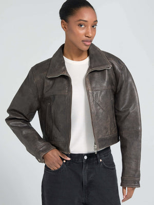 Stylish cropped brown leather jacket on a model, featuring a classic collar and zip closure, perfect for a trendy look by MEOTINE.