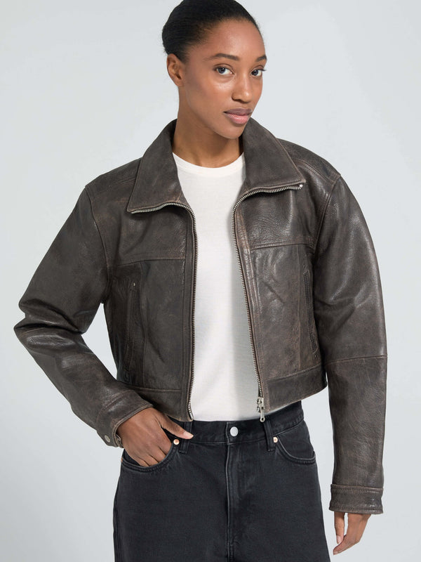 Stylish cropped brown leather jacket on a model, featuring a classic collar and zip closure, perfect for a trendy look by MEOTINE.