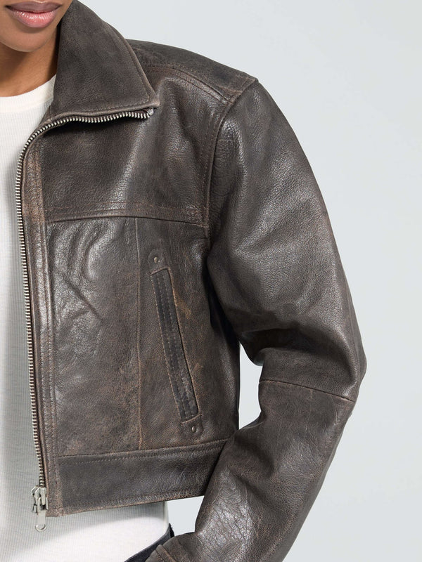 Stylish cropped brown leather jacket with a zip closure and side pockets, perfect for a trendy look by MEOTINE.