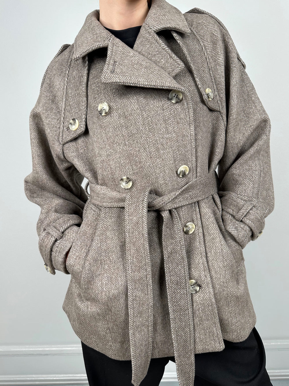 Stylish herringbone coat with a belted waist and double-breasted buttons, perfect for a chic look by MEOTINE.