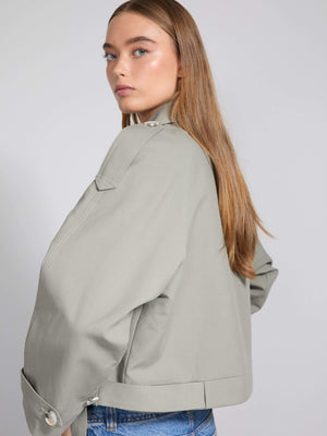 Stylish light gray jacket with a relaxed fit, featuring a high collar and button details, perfect for a modern look by MEOTINE.